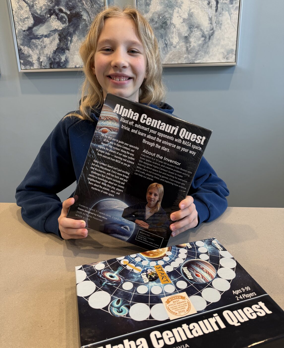 Kaia Minn holding the Alpha Centauri Quest board game box